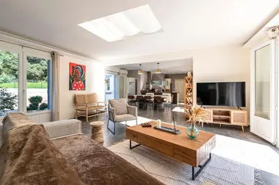 a living room with a couch and a table at Sòle - Peri - Maison climatisée avec piscine in Peri