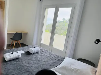 a bedroom with a bed with two towels on it at Villa Mare è Machja avec piscine et vue mer in Sari Solenzara