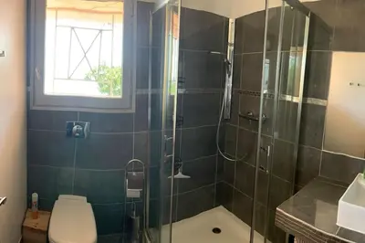 a bathroom with a shower with a toilet and a sink at Maison Corallo splendide vue mer in Porto-Vecchio