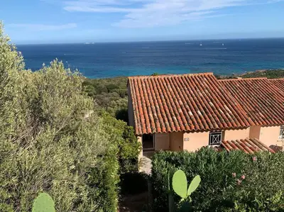 an image of a house with the ocean in the background at Maison Corallo splendide vue mer in Porto-Vecchio