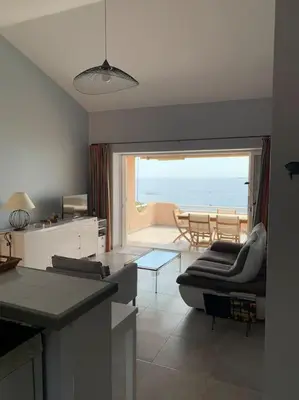 a living room with a couch and a table at Maison Corallo splendide vue mer in Porto-Vecchio