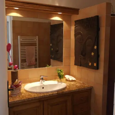 a bathroom with a sink and a mirror at Residence CORSE AZUR AJACCIO in Ajaccio