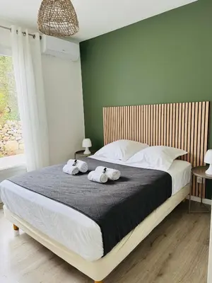 a bedroom with a large bed with towels on it at Appartement Mare è Machja vue mer in Sari Solenzara