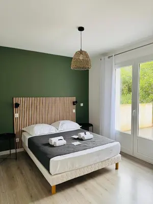 a bedroom with a bed with two towels on it at Appartement Mare è Machja vue mer in Sari Solenzara