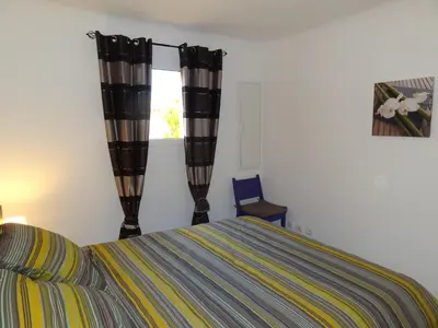 a bedroom with a bed and a window at Résidence Santa Giulia Park 1 avec piscine à proximité des plages in Porto-Vecchio