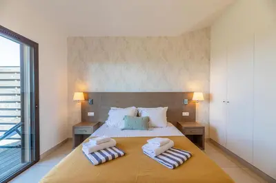 a bedroom with a bed with two towels on it at Résidence Les Terrasses de Rondinara in Bonifacio