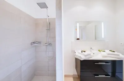 a bathroom with a sink and a shower at Résidence Les Terrasses de Rondinara in Bonifacio