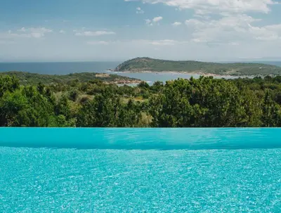 a swimming pool with a view of the ocean at Résidence Les Terrasses de Rondinara in Bonifacio
