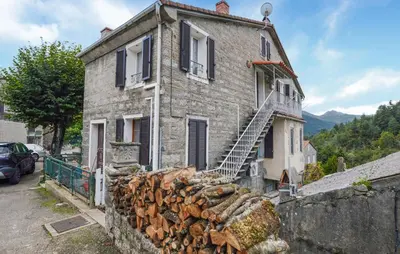 an old stone house with a pile of fire wood at Stunning Apartment In Ciamannacce in Ciamannacce