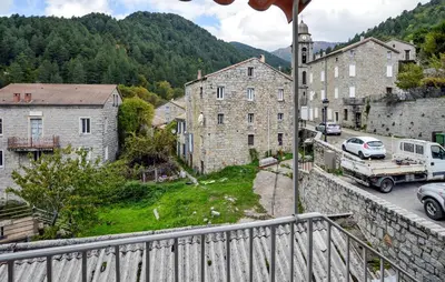 a view from a balcony of a town with a truck at Stunning Apartment In Ciamannacce in Ciamannacce