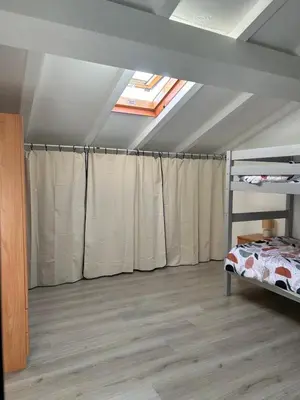 a bedroom with a bed and a skylight at Appartement dans résidence avec piscine et plage privées in San-Nicolao