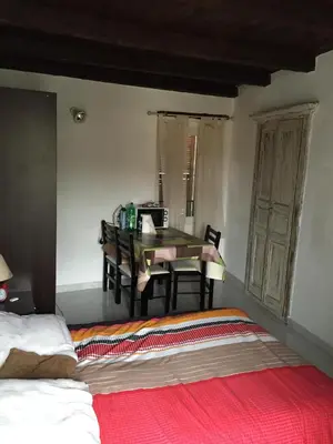 a bedroom with a bed and a table and chairs at Studio Haute Ville in Corte