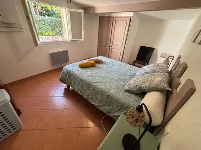 a bedroom with a bed with a stuffed animal on it at Caseddu jardin et mer in Viggianello