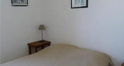 a bedroom with a bed and a lamp on a table at Résidence Fioravanti Villas Valinco in Tizzano