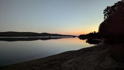 a view of a body of water at sunset at Appart 70m2 avec loggia, piscine à débordement vue mer in Pianottoli-Caldarello