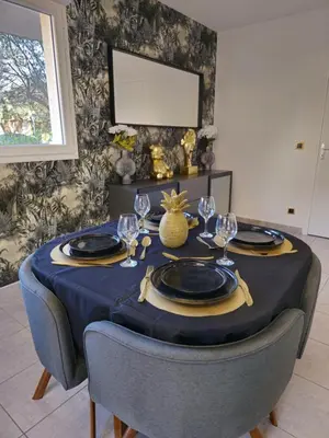 a table with a blue table cloth and glasses on it at Casa Ghjulia 4 étoiles à Porto-Vecchio centre-ville in Porto-Vecchio