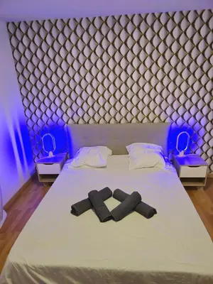a bed with two pairs of slippers on it at Casa Ghjulia 4 étoiles à Porto-Vecchio centre-ville in Porto-Vecchio