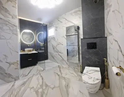 a marble bathroom with a toilet and a sink at Casa Ghjulia 4 étoiles à Porto-Vecchio centre-ville in Porto-Vecchio