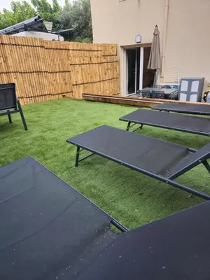 two ping pong tables on the grass in a backyard at Casa Ghjulia 4 étoiles à Porto-Vecchio centre-ville in Porto-Vecchio
