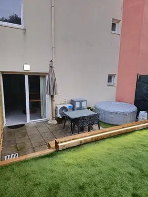 a patio with a table and a bed and an umbrella at Casa Ghjulia 4 étoiles à Porto-Vecchio centre-ville in Porto-Vecchio