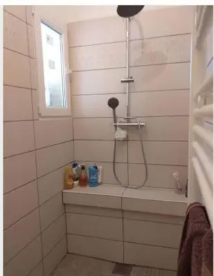 a bathroom with a shower with a sink and a tub at Appartement T2 Belvedere campomoro in Portigliolo