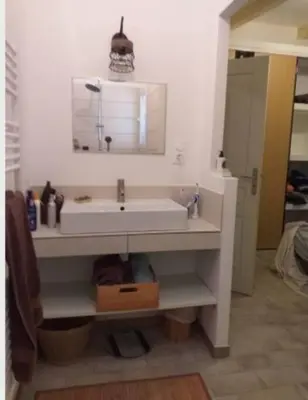 a bathroom with a white sink and a mirror at Appartement T2 Belvedere campomoro in Portigliolo