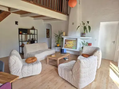 a living room with two white chairs and a table at La Bohème, route de Pinarello in Sainte-Lucie de Porto-Vecchio