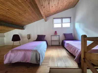 a bedroom with two beds and a wooden ceiling at La Bohème, route de Pinarello in Sainte-Lucie de Porto-Vecchio