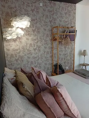 a bedroom with a bed and a wall with wallpaper at Résidence A Casetta in Monacia-dʼAullène