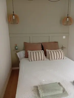 a bed with two pillows on it in a room at Résidence A Casetta in Monacia-dʼAullène