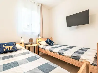 a bedroom with two beds and a flat screen tv at Apartment Mido by Interhome in Linguizzetta