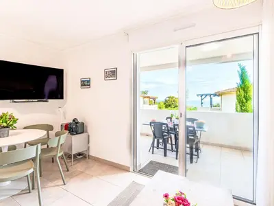 a room with a balcony with a table and chairs at Apartment Mido by Interhome in Linguizzetta