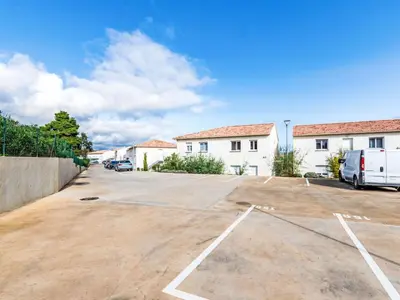 a parking lot in front of a building at Apartment Mido by Interhome in Linguizzetta