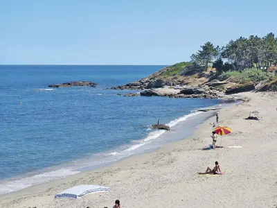 a group of people on a beach with an umbrella at Apartment Mido by Interhome in Linguizzetta