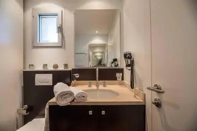 a bathroom with a tub and a sink with a mirror at Appartement 4* piscine et plage à pied in Porto-Vecchio