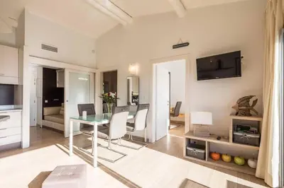 a living room with a glass table and chairs at Appartement 4* piscine et plage à pied in Porto-Vecchio