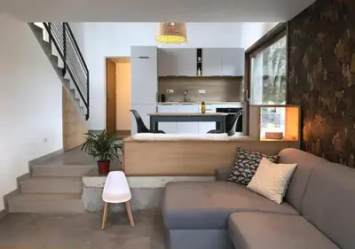 a living room with a couch and a kitchen at Villa d'architecte in Sotta