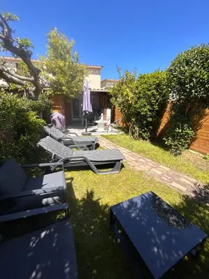 a group of chairs and tables in a yard at Maison bord de mer in Poggio-Mezzana