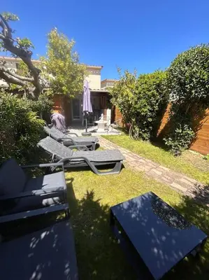 a group of chairs and tables in a yard at Maison bord de mer in Poggio-Mezzana