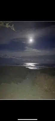a view of the ocean with the moon in the sky at Maison bord de mer in Poggio-Mezzana