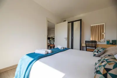 a bedroom with a large white bed with towels on it at Appartement 4 étoiles piscine et plage à pied in Porto-Vecchio
