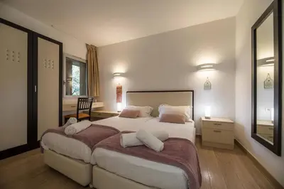 a bedroom with a large bed with two pillows at Appartement 4 étoiles piscine et plage à pied in Porto-Vecchio