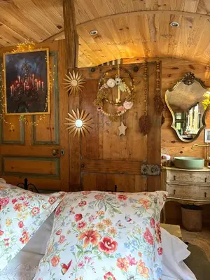 a bedroom with a bed with a wooden wall at Roulotte insolite U tragulinu in Zonza