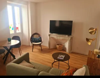 a living room with a couch and a fireplace at T2 centre ville Ajaccio in Ajaccio