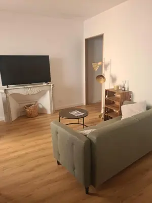a living room with a couch and a flat screen tv at T2 centre ville Ajaccio in Ajaccio