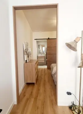 a room with a bedroom with a bed and a mirror at T2 centre ville Ajaccio in Ajaccio