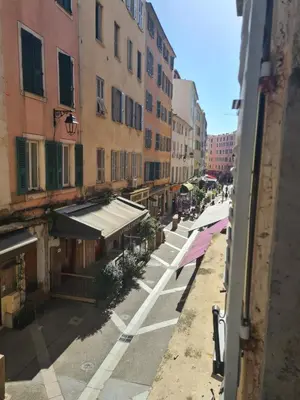 a view of a street with buildings and umbrellas at T2 centre ville Ajaccio in Ajaccio