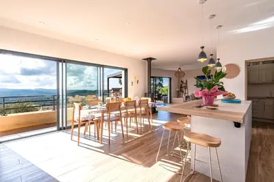 a kitchen and dining room with a table and chairs at Maison Altea - Maison climatisée in Figari