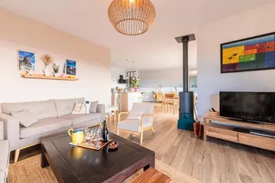 a living room with a couch and a tv at Maison Altea - Maison climatisée in Figari