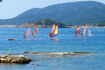 a group of sailboats on a body of water at Village Naturiste La Chiappa in Porto-Vecchio